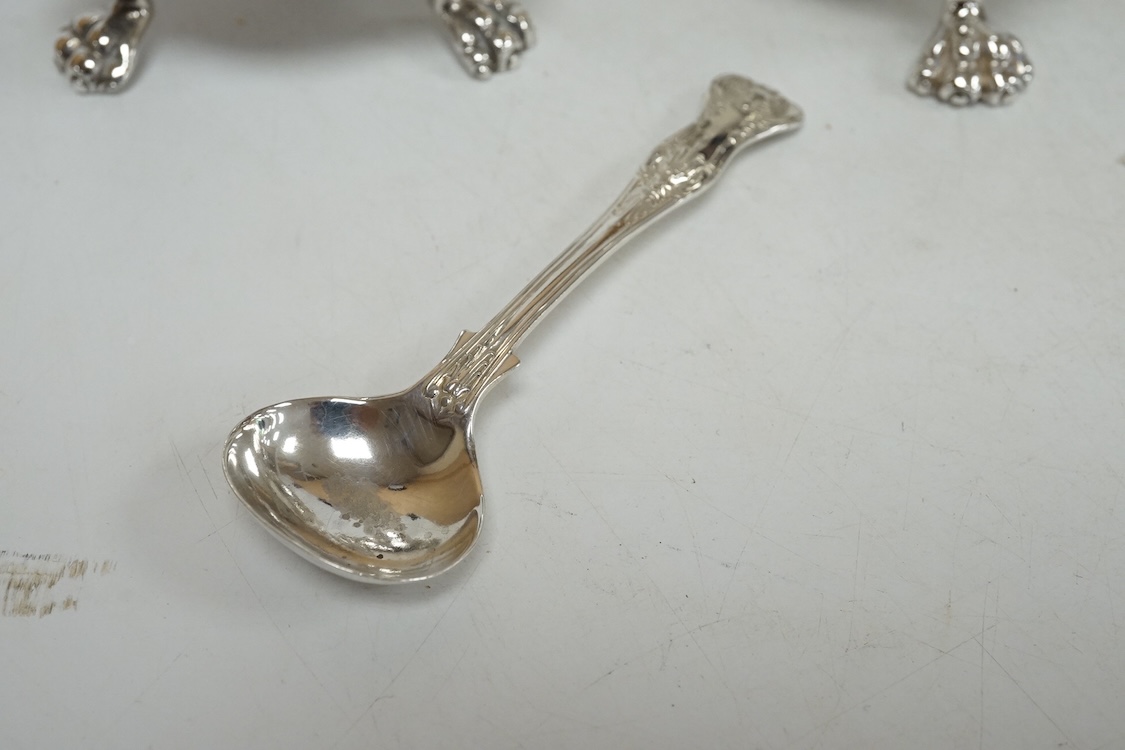 A George VI silver three piece condiment set by Mappin & Webb, London, 1937, with blue glass liners, one associated, pepper, 13.9cm, 26.5oz.